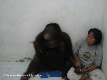 Kiki sitting with one of her caregivers at the Care Center.