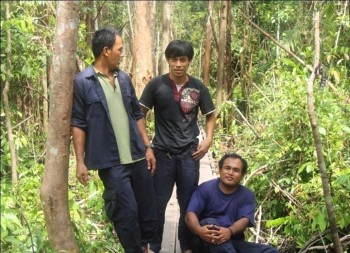 At home in the forest, Pak Ateng (center) with fellow co-workers, Pak Manis (left) and Pak Midi (right)