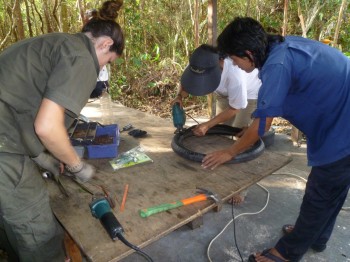 Staff and volunteer cutting tires for hammocks and other projects