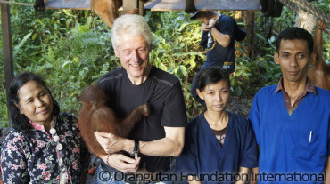 Clinton holding orangutan